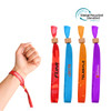 A hand displaying four RPET fabric wristbands in red, orange, yellow, and purple, featuring bamboo toggles and logos.