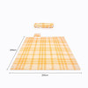 A picnic blanket measuring 200x200 cm, featuring a yellow and cream check pattern, with a rolled handle visible.