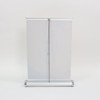 A silver and white A4 countertop pull-up banner with a sleek design, featuring a branding logo.