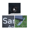 Close-up of a black barrier with a metal eyelet, logo, and a stabilising foot on grass.