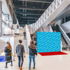 A blue straight fabric popup display with a branding logo, set in a modern atrium. People are walking nearby.