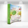 Curved fabric popup display featuring a vibrant design with a cup of milk and grains, predominantly green and white.
