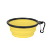 A collapsible silicone bowl in yellow with a black rim and a carabiner attached for easy carrying.