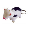 A keyring featuring a white and black cow stress reliever with a silver keyring attachment.