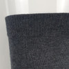 A pair of dark grey business socks displayed upright, featuring a soft, textured knit. The image includes a logo.