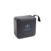 A portable wireless Bluetooth speaker in black with a textured surface and a carrying strap. It features a logo on the front.
