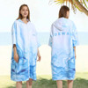 A hooded change towel in a blue and white marbled design, featuring a zip and a logo on the back.