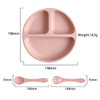 A silicone kids suction plate in soft pink with three compartments, accompanied by a matching spoon and fork.