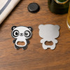 A drink bottle opener in the shape of a panda, featuring a black and white design, on a wooden surface.