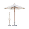 A 4x4m wind-resistant octagon outdoor umbrella in white with a wooden pole and a matching folded umbrella nearby.