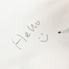A5 whiteboard notebook featuring a handwritten note and smiley face, with a black marker on a white background.