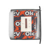 A small table runner in vibrant red and blue patterns, packaged in a clear zippered pouch, with a logo visible.