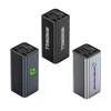 A collection of three power banks in black, silver, and dark grey, featuring digital displays and various logos.