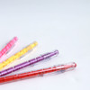 A set of colourful pens in pink, yellow, purple, and red, each featuring a maze design on the barrel.
