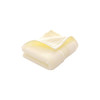 A folded embroidered cotton hand towel in soft yellow, featuring a subtle texture and a logo.