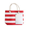 A red and white striped tote bag with a rope handle and a tablet resting against the side.