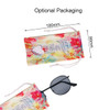 A pair of classic metal sunglasses rests inside a colourful drawstring pouch with a heart design.