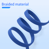 A long, braided charging cable in navy blue, coiled in a spiral shape against a light background.