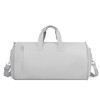 A grey convertible duffel bag with sturdy handles and a detachable shoulder strap, featuring a zippered compartment.