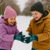 Two children wearing colourful winter clothing, including a pink beanie, purple jacket, and brown coat, joyfully holding a snowball.