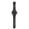 A black smart watch with a round face and a silicone strap, featuring a metallic bezel and a logo.
