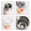 A drink bottle in light pink with a stainless steel interior and a removable orange lid, alongside a clear cup.