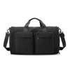 A foldable travel duffle bag in black featuring two front pockets and a detachable shoulder strap.