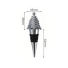 A drink bottle stopper featuring a festive silver Christmas tree design with a black silicone base.