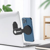 A black plastic magnetic phone holder attached to a silver laptop, supporting a blue smartphone.