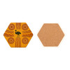A hexagon ceramic coaster featuring a yellow design with Aboriginal art and a cork backing.
