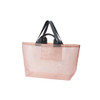 A large mesh beach tote bag in soft pink with dark grey handles, featuring a simple design and a logo.