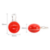 A red dog walking LED light with a silver clip, designed in a rounded shape. Dimensions are 55mm by 35mm by 25mm.