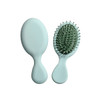 A mini paddle brush in mint green with a smooth handle and flexible bristles. The product has a simple design.