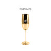 A gold stainless steel champagne flute with a sleek design and a logo on the side.