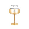 A stainless steel cocktail coupe in a shiny gold finish, featuring a logo on the side.