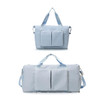 A light blue foldable sports duffle bag with two front pockets and dual handles. It features a detachable shoulder strap.