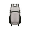 A light grey packable hiking backpack with black accents and mesh side pockets. It features adjustable straps and a zippered front pocket.