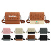 A range of EVA Holes Briefcases in brown, pink, cream, black, and grey, each with a logo and perforated design.