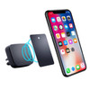 A black universal magnetic car mount with a metal plate, positioned near a smartphone displaying various apps.