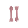 A bear-shaped silicone kids cutlery set in soft pink, featuring a spoon and fork with bear-shaped ends.