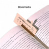 A pink bookmark featuring a calendar design, inserted in an open book, with a subtle logo visible.