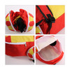 A foldable gym bag in bright red and yellow with a zippered opening and straps, featuring a logo.