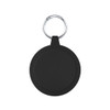 A round black keychain holder features a silver keyring. The surface is smooth with subtle grooves around the edge.