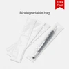A black aluminum gel pen displayed in a biodegradable bag, alongside two empty bags. The product has a logo.