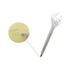 A silver ballpoint pen shaped like a spanner rests next to a note with handwritten text on it.