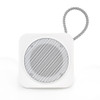 A white portable speaker with a metallic mesh grille and a wire loop for hanging.