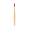 A large flat handle toothbrush with a bamboo body and a pink bristle head, featuring a logo.