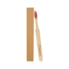 A bamboo toothbrush with a large flat handle and pink bristles, packaged in a brown cardboard box.