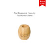 A small bamboo toothbrush holder with a circular opening and engraved branding. The holder is light brown in colour.