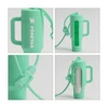A mint green lip balm holder keychain with a handle and a transparent section, featuring a logo.